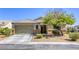 Charming single-story home featuring a xeriscaped front yard and two-car garage at 1208 Neva Ranch Ave, North Las Vegas, NV 89081