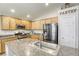 Bright kitchen featuring granite countertops, a large island, stainless steel appliances, and abundant storage space at 1208 Neva Ranch Ave, North Las Vegas, NV 89081