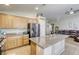 Open concept kitchen with granite countertops, stainless steel appliances, ample storage, and breakfast bar seating at 1208 Neva Ranch Ave, North Las Vegas, NV 89081