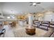 Open-concept living room and kitchen featuring tile floors, an island, and a modern, neutral color palette at 1208 Neva Ranch Ave, North Las Vegas, NV 89081