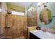 Bathroom featuring stylish glass shower, stone accents, modern fixtures, and decorative mirror at 151 Enloe St, Henderson, NV 89074