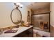 Bathroom with dark cabinets, granite countertop, and a tiled shower-tub combination at 151 Enloe St, Henderson, NV 89074