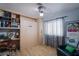 Multi-purpose bedroom with built-in shelving, desk, murphy bed, and modern ceiling fan at 151 Enloe St, Henderson, NV 89074