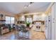 Well-lit kitchen featuring white cabinets, center island, and tile backsplash at 151 Enloe St, Henderson, NV 89074