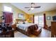 Comfortable primary bedroom with hardwood floors, a ceiling fan, and a sliding glass door at 151 Enloe St, Henderson, NV 89074