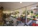 Covered patio overlooking a backyard oasis complete with seating, plants, and waterfall feature at 151 Enloe St, Henderson, NV 89074