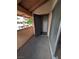 Outdoor balcony featuring gray concrete floors, a sliding glass door, and view of the neighborhood at 1515 E Reno Ave # C207, Las Vegas, NV 89119