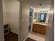 Bathroom view with vanity, mirror, and walk-in closet on the left featuring shelving units at 1515 E Reno Ave # C207, Las Vegas, NV 89119