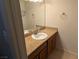 Bathroom vanity with a white sink, granite countertop, and wooden cabinets for storage at 1515 E Reno Ave # C207, Las Vegas, NV 89119