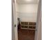 Closet with wooden floor and shelving units for storage, with a vacuum cleaner on the side at 1515 E Reno Ave # C207, Las Vegas, NV 89119