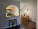 Bright dining area with dark wood floors adjacent to an open kitchen featuring stainless steel appliances at 1515 E Reno Ave # C207, Las Vegas, NV 89119