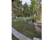 Landscape view of the yard featuring greenery, mature trees, and walkways at 1515 E Reno Ave # C207, Las Vegas, NV 89119