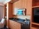 Stylish kitchenette with granite countertops and wood cabinetry at 2000 N Fashion Show Dr # 2627, Las Vegas, NV 89109