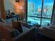 Cozy living room with comfortable seating, a glass coffee table, and a large window with city views at 2000 N Fashion Show Dr # 2627, Las Vegas, NV 89109
