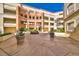 Beautiful courtyard with fountain and desert landscaping, surrounded by balconies and architectural details at 230 E Flamingo Rd # 229, Las Vegas, NV 89169