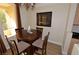 Dining area with round wooden table and decorative chandelier near sunlit balcony at 230 E Flamingo Rd # 229, Las Vegas, NV 89169