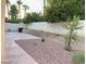 Backyard featuring decorative gravel, patio and a tall perimeter wall with landscaping at 2366 Brockton Way, Henderson, NV 89074