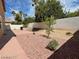 Spacious backyard featuring rock landscaping, mature trees, and a concrete patio, perfect for outdoor enjoyment at 2366 Brockton Way, Henderson, NV 89074