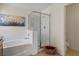 Bright bathroom features a soaking tub with tile surround and glass enclosed shower stall at 2366 Brockton Way, Henderson, NV 89074