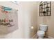 Neutral powder room featuring a toilet, decorative towel and wall hangings at 2366 Brockton Way, Henderson, NV 89074