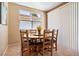 Cozy breakfast nook with a wood table, six chairs, and natural light from the nearby window at 2366 Brockton Way, Henderson, NV 89074