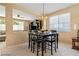 Bright dining area adjacent to the living room, featuring a stylish chandelier and ample natural light at 2366 Brockton Way, Henderson, NV 89074