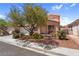 Charming single-Gathering home featuring a manicured front yard, mature tree, and cozy front porch at 2366 Brockton Way, Henderson, NV 89074