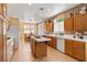 Spacious kitchen with an island, tile countertops, and natural wood cabinetry at 2366 Brockton Way, Henderson, NV 89074
