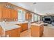 An eat-in kitchen featuring granite countertops and a center island with sight lines to the living room at 2366 Brockton Way, Henderson, NV 89074