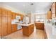 Bright kitchen with wood cabinets, central island and stainless steel appliances at 2366 Brockton Way, Henderson, NV 89074
