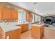 Well-lit kitchen with tile floors, white counters and views into the adjacent living area at 2366 Brockton Way, Henderson, NV 89074
