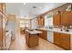 Bright kitchen featuring wood cabinetry, a center island, and a seamless transition to the dining area at 2366 Brockton Way, Henderson, NV 89074