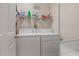 Convenient laundry room equipped with a washer, dryer, and shelving for storage at 2366 Brockton Way, Henderson, NV 89074