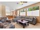 Open living space with a plush sectional, large windows, and seamless access to the kitchen and dining areas at 2366 Brockton Way, Henderson, NV 89074