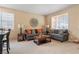 Comfortable living room with natural light, stylish sofas, and a decorative clock, ideal for relaxing at 2366 Brockton Way, Henderson, NV 89074