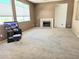 Spacious living room features a fireplace, neutral carpet, and large windows for natural light at 2366 Brockton Way, Henderson, NV 89074