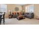 Cozy living room featuring neutral paint, natural light, and comfortable seating, perfect for relaxing at 2366 Brockton Way, Henderson, NV 89074