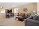Inviting living room featuring neutral tones, comfortable seating, and seamless flow to the dining area at 2366 Brockton Way, Henderson, NV 89074