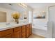 Bright bathroom with dual sinks, soaking tub, glass shower, and decorative touches at 2366 Brockton Way, Henderson, NV 89074