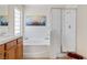 Bright bathroom featuring a soaking tub, glass shower and double vanity at 2366 Brockton Way, Henderson, NV 89074