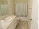 Bathroom with a single vanity, with white cabinets, and a shower/tub combo with blue shower curtain at 241 Honeywood St, Henderson, NV 89074