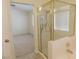 Bright bathroom with a glass-enclosed shower and soaking tub, complemented by neutral tiling at 241 Honeywood St, Henderson, NV 89074
