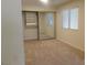 Bright bedroom featuring neutral carpet, mirrored closet doors, and natural light from the window at 241 Honeywood St, Henderson, NV 89074
