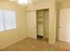 Bedroom with plush carpet, a closet with sliding doors, and a window with blinds at 241 Honeywood St, Henderson, NV 89074