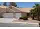 Inviting single-story home with two-car garage, desert landscaping, and a tile roof at 241 Honeywood St, Henderson, NV 89074