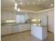Bright kitchen with white cabinets, updated appliances, and a central island for seating at 241 Honeywood St, Henderson, NV 89074