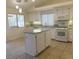 Open-concept kitchen featuring white cabinets, stainless steel appliances, and a kitchen island at 241 Honeywood St, Henderson, NV 89074