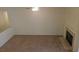 Cozy living room with a fireplace, neutral walls, and soft carpet flooring at 241 Honeywood St, Henderson, NV 89074