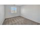 Bedroom featuring carpet floors, white walls, window with blinds, and ample natural light at 2431 Lilac Cove St, Las Vegas, NV 89135