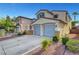 Charming two-story home with attached two-car garage and desert landscaping at 2431 Lilac Cove St, Las Vegas, NV 89135